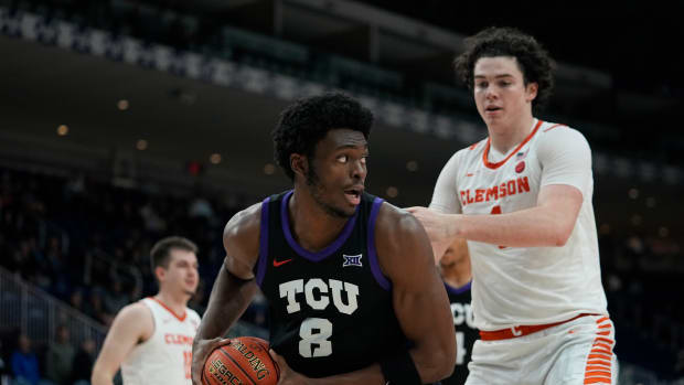 Dec 9, 2023; Toronto, Ontario, CAN; TCU Horned Frogs center Ernest Udeh Jr. (8) grabs a rebound against Clemson Tigers forward Ian Schieffelin (4) during the second half at Coca-Cola Coliseum. Mandatory Credit: John E. Sokolowski-USA TODAY Sports  
